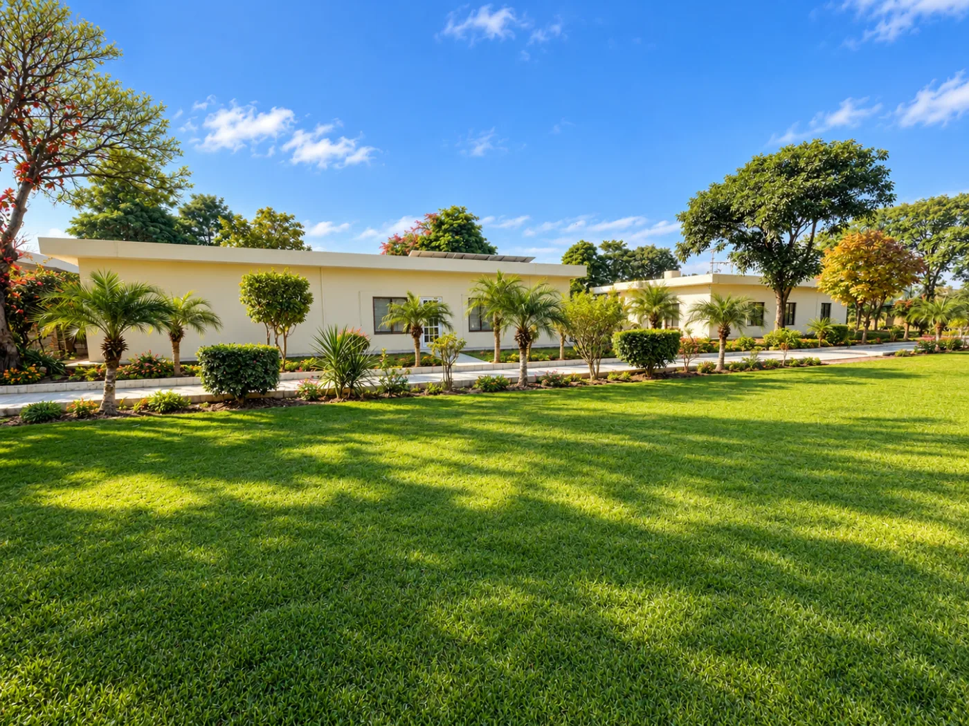 The GIHD Mandra campus teaching block behind its lawn and planted walkway