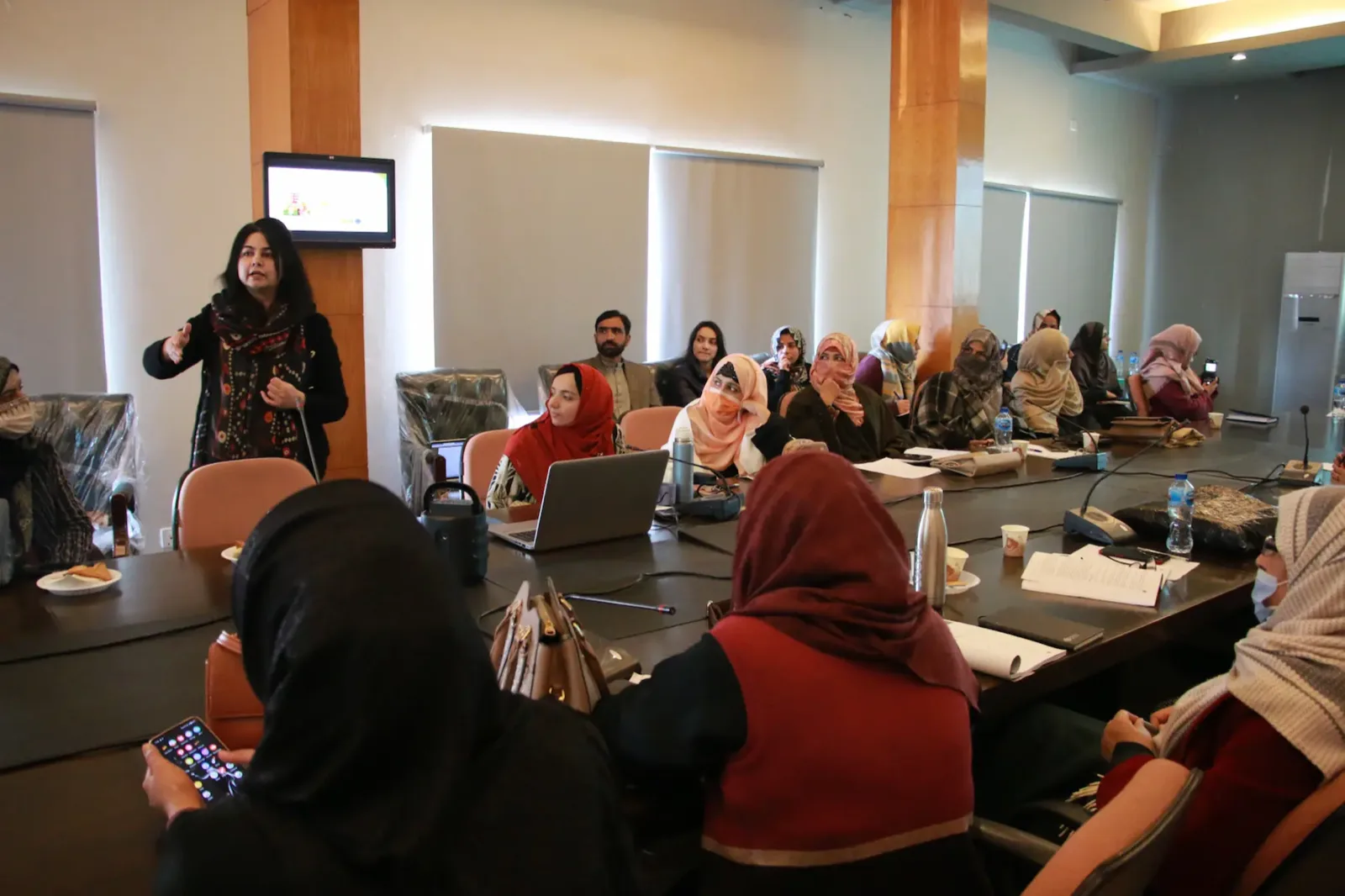 A GIHD researcher presenting to a roomful of colleagues