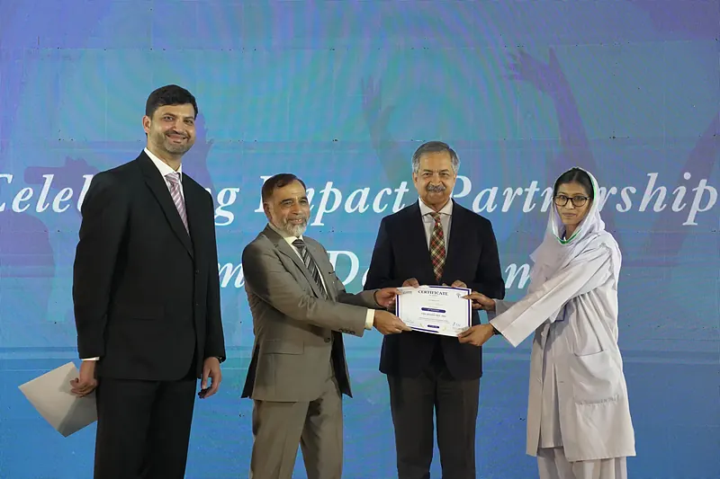 Certificate of Merit presented by Dr. Malik Muhammad Safi, Senior Health Advisor, Ministry of National Health Services, Regulation and Coordination, alongside Prof. Dr. M. Iqbal Khan, Vice Chancellor Shifa Tameer-e-Millat University, CMW Session 2024 to 2026, IPHNM Annual Day 2026